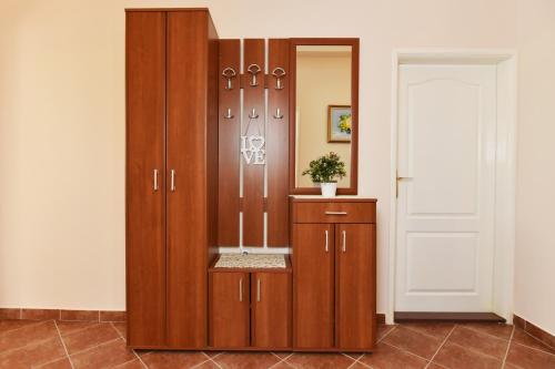 duża drewniana szafka w pokoju obok drzwi w obiekcie Apartments Marko w mieście Herceg Novi