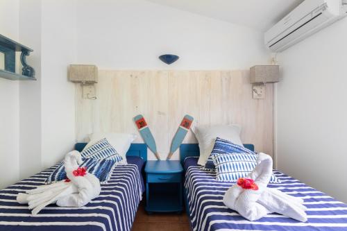 Ένα ή περισσότερα κρεβάτια σε δωμάτιο στο Villa Alizé & Villa Aigue-Marine