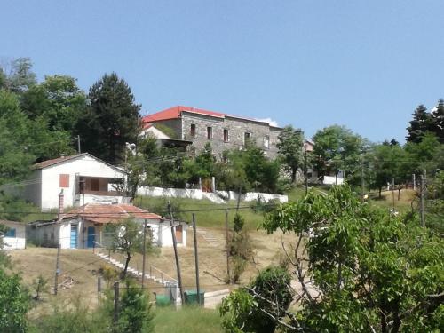an old building on top of a hill with trees at The Magic Mountain in Tsapournia