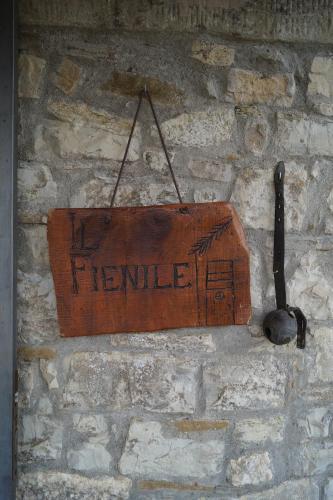 a sign hanging on a brick wall at Il Borghetto di Carra in Talla