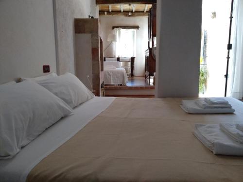a bedroom with a large bed with two towels on it at Ca' de Pria in Borgio Verezzi