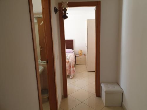 a hallway of a bedroom with a bed and a doorway at Via Pasquale Testa in Formia