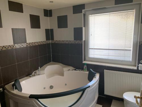 a bath tub in a bathroom with a window at Nexi s Appartement an der Enns 9 in Radstadt