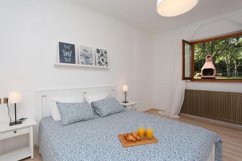 a bedroom with a bed with a tray of oranges on it at House Pauline in Labin