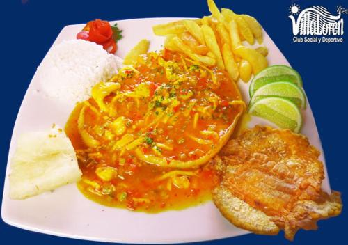 a plate of food with meat and cheese and french fries at VillaLoren in San Antonio del Tequendama