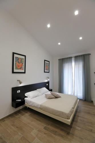 a bedroom with a large bed and a window at Agrigentumbreakfast in Agrigento