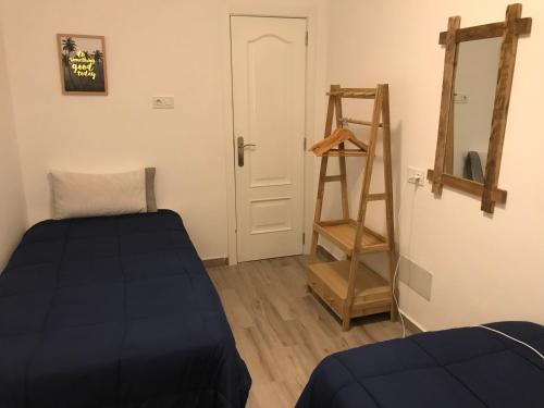 a room with a bed and a ladder next to a door at Fuerteventura Family Luxury in Morro del Jable