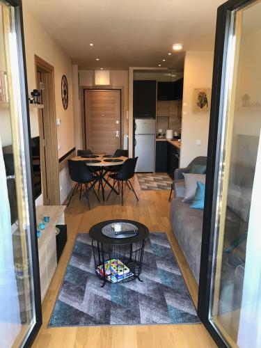 a living room with a couch and a table at Zlatibor apartman Chill out in Zlatibor