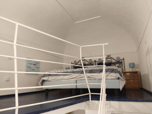 a bedroom with a bed with a metal frame at Il Moscardino in Vico Equense