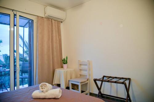 a room with a bed and a table and a chair at Blue Star 2 in Pyrgi Thermis