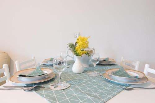 a dining room table with a blue and white table cloth at Apartment Calista in Rabac
