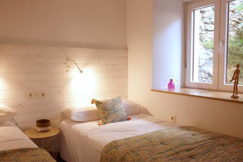 a bedroom with two beds and a window at TALA FLAT in Lekeitio