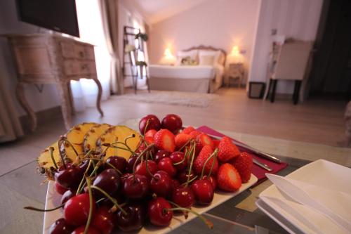 
a table topped with lots of fruits and vegetables at Le Petit Boutique Hotel in Santander
