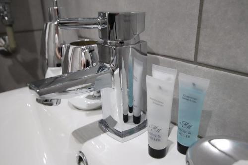 a sink with a faucet and two toothbrushes at Halifax House, Studio Apartment 209 in Halifax