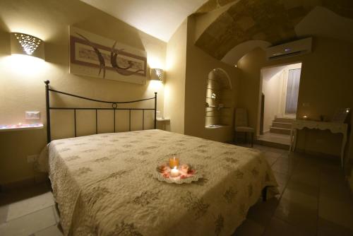 a bedroom with a bed with candles on it at B&B Corte Cantalupi in Gallipoli