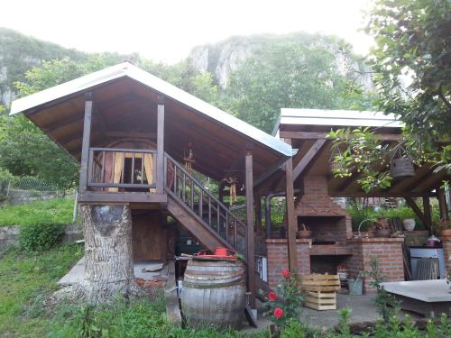 a tree house with a staircase and a barrel at Golemi kamik Pirot in Pirot