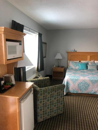 a hotel room with a bed and a living room at The Atlantic House in Narragansett