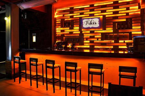a bar with a row of stools in a restaurant at Hotel Jardines de Uyuni in Uyuni