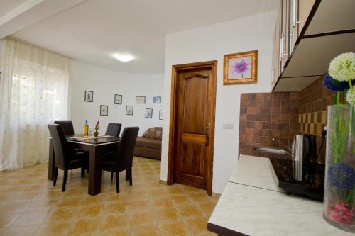 a kitchen and dining room with a table and chairs at Apartments Dora in Dobra Voda