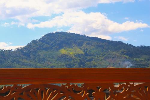 a mountain with a green hill in the background at Apartamentos Primavera in Jardin