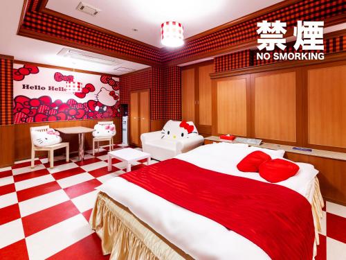 a bedroom with a large bed and a no smoking sign at Hotel Mine (Love Hotel) in Kurume