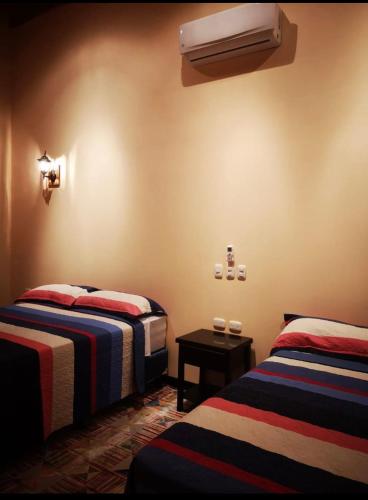 a hotel room with two beds and a heater at Millenium Manuel Antonio Park and beach in Manuel Antonio