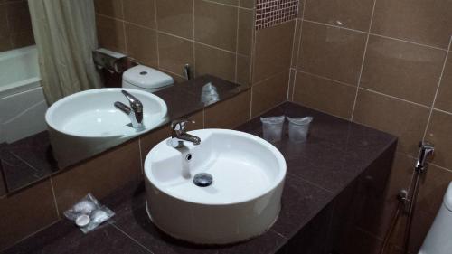 a bathroom with a sink and a mirror at RHR Hotel Kajang in Kajang