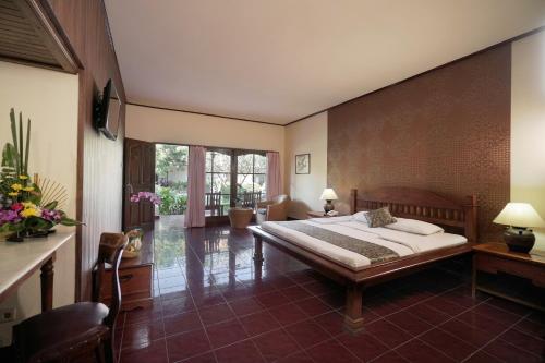 een slaapkamer met een groot bed in een kamer bij Bumas Hotel in Sanur