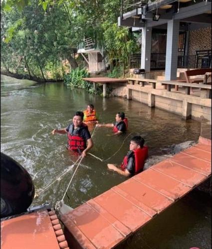 a group of children are in the water at Kaengkrachan River Hut in Kaeng Krachan
