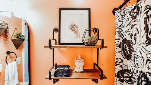 a shelf in a bathroom with a picture on it at West Davis Mill in Culpeper