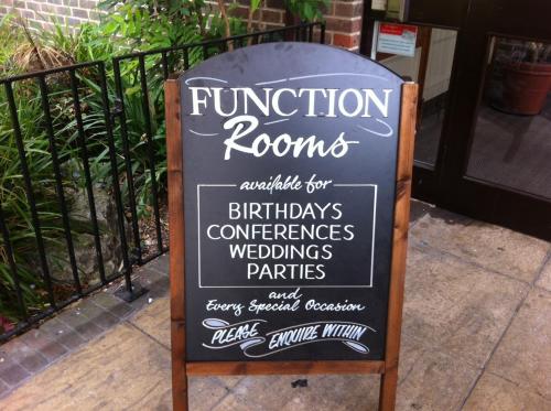 a chalkboard sign for a function rooms at Farmhouse Innlodge by Greene King Inns in Portsmouth
