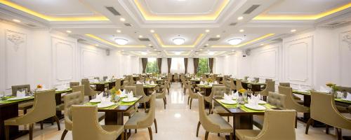 a large dining room with tables and chairs at Roliva Hotel & Apartment Danang in Da Nang