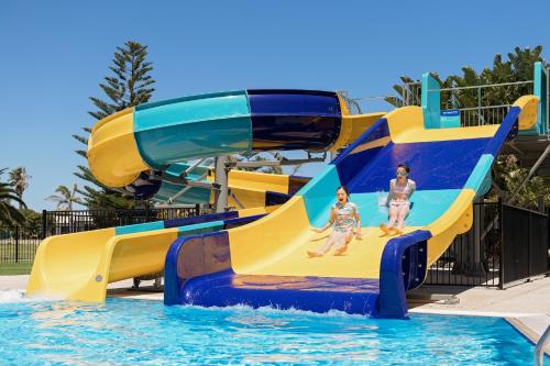 two children on a water slide at a water park at The Retreat West Beach Parks in Adelaide