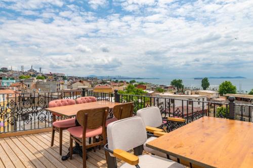 a balcony with tables and chairs and a view of the city at Golden Sand Hotel in Istanbul