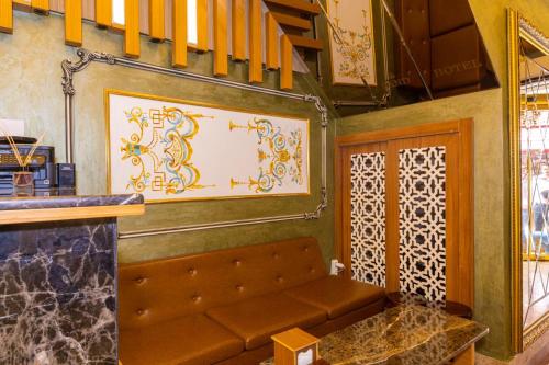 a room with a bench and a wall with a painting at Golden Sand Hotel in Istanbul