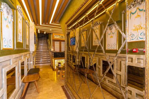 a hallway of a building with a staircase and a chair at Golden Sand Hotel in Istanbul