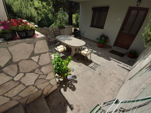 a patio with a table and chairs in front of a house at Studio Jeff 1 in Kotor