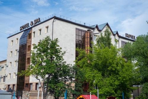 a building with a sign on the side of it at Skif HOTEL & SPA in Petropavlovsk