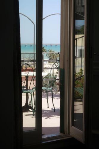 an open door to a patio with a table and chairs at La Dolce Vista - B&B di Charme in Manfredonia