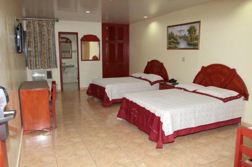 Postel nebo postele na pokoji v ubytování Hotel Alcala