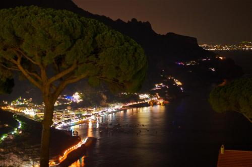 a view of a river at night with a city at Villa Casale Ravello Residence in Ravello