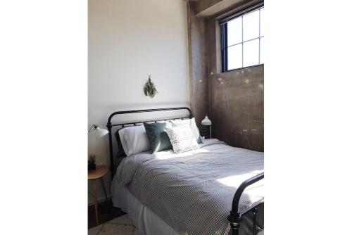 a bedroom with a bed and a window at City Loft w/ View of Gay St in Knoxville