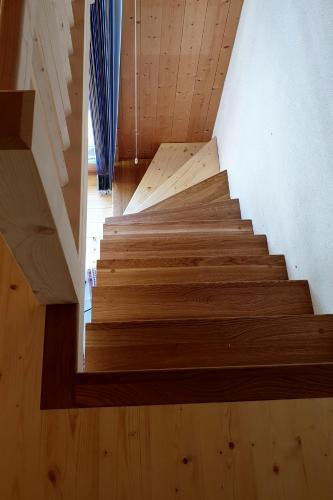 a wooden staircase in a house with wooden floors at Ferienhaus & Ferienwohnung Wiñay Wayna Gotschna Blick Klosters in Klosters Serneus