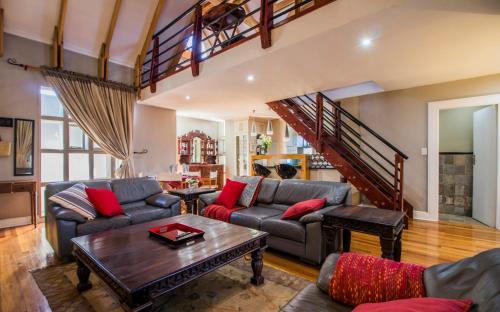 a living room with a couch and a table at Craigivar Guesthouse in Pretoria