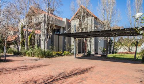 a house with a pavilion on a brick road at Craigivar Guesthouse in Pretoria