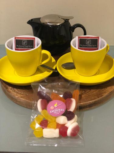 a table with two cups and a box of candy at Lochiel Luxury Accommodation in Olinda
