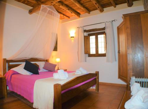 a bedroom with a bed and a window and a mirror at Can Vich Petit in Sant Carles de Peralta