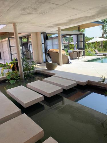 a house with a swimming pool and a patio at Laman Villa Port Dickson in Port Dickson