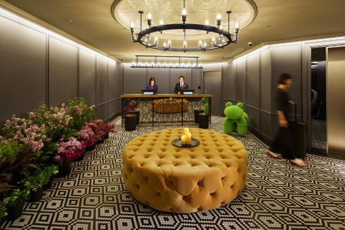 a lobby with a table with a candle on it at Hotel Resol Yokohama Sakuragicho in Yokohama