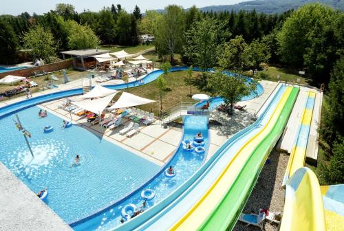 an overhead view of a large swimming pool with people in it at Honey Paradise glamping resort in Dobova